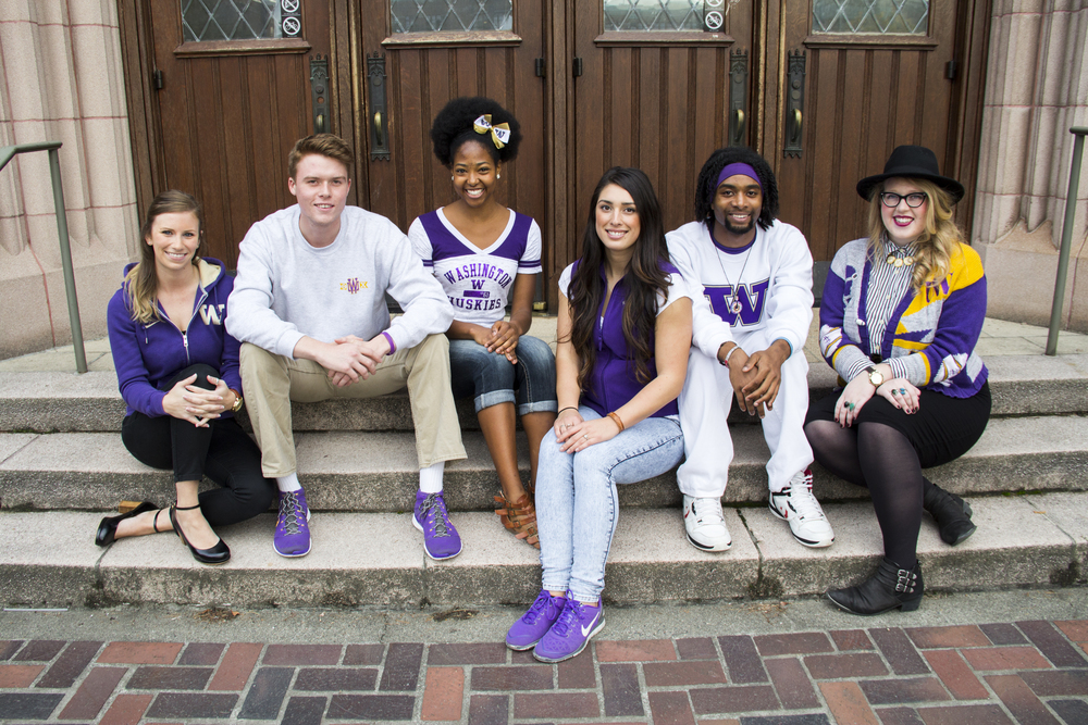 Six University of Washington students sit posed on the concrete stairs outside of a brick building.